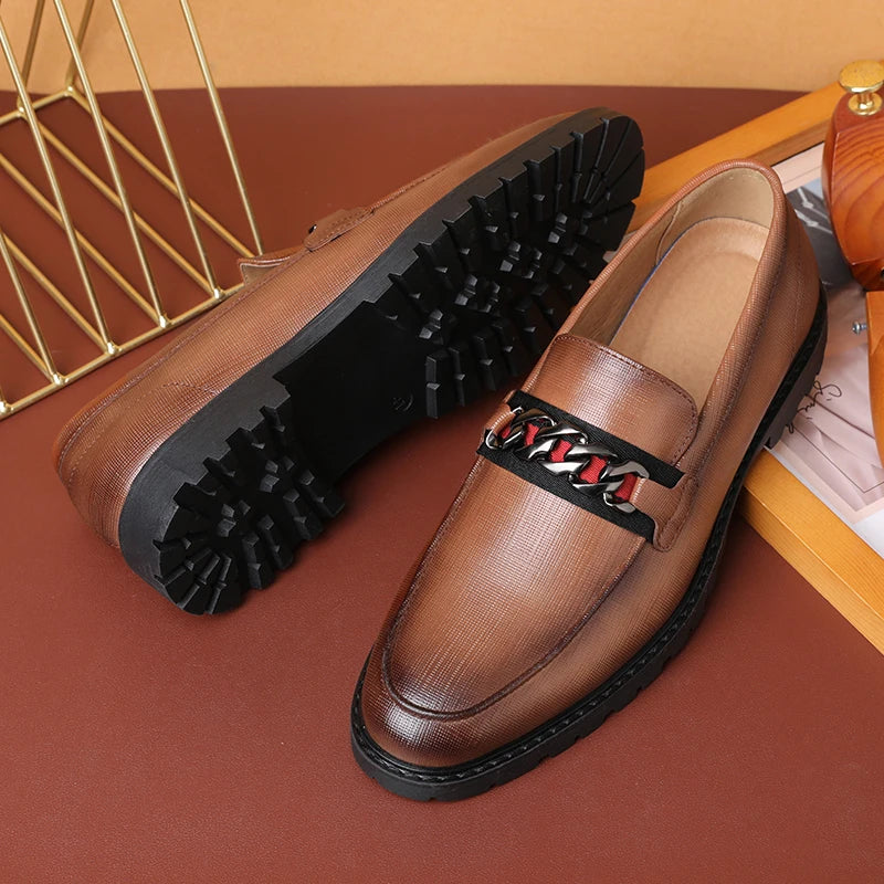 Brown leather loafer with chain detail from Henri Rousseau Deri, featuring textured sole