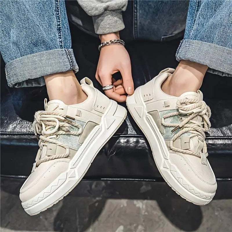 Cream-colored Vortex erkek sneakers with chunky soles and rolled-up denim jeans