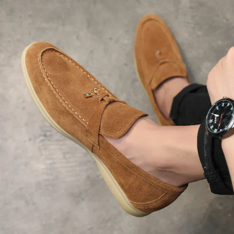 Tan suede Intrigante loafer with decorative stitching and light-colored sole